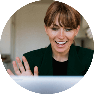 Man sitting smiling at his laptop while on a telehealth consult.